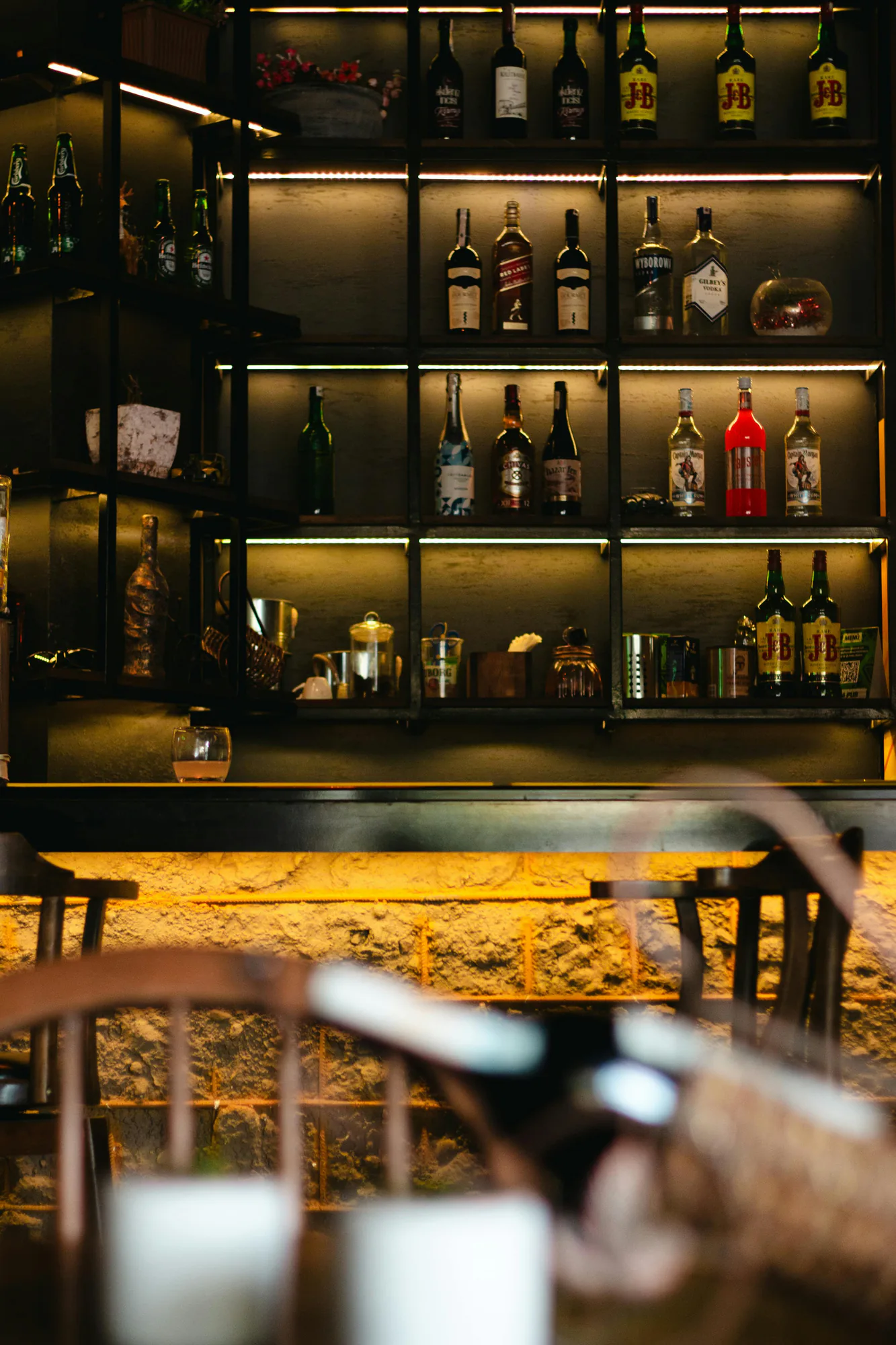 Backlit bar shelves lined with bottles